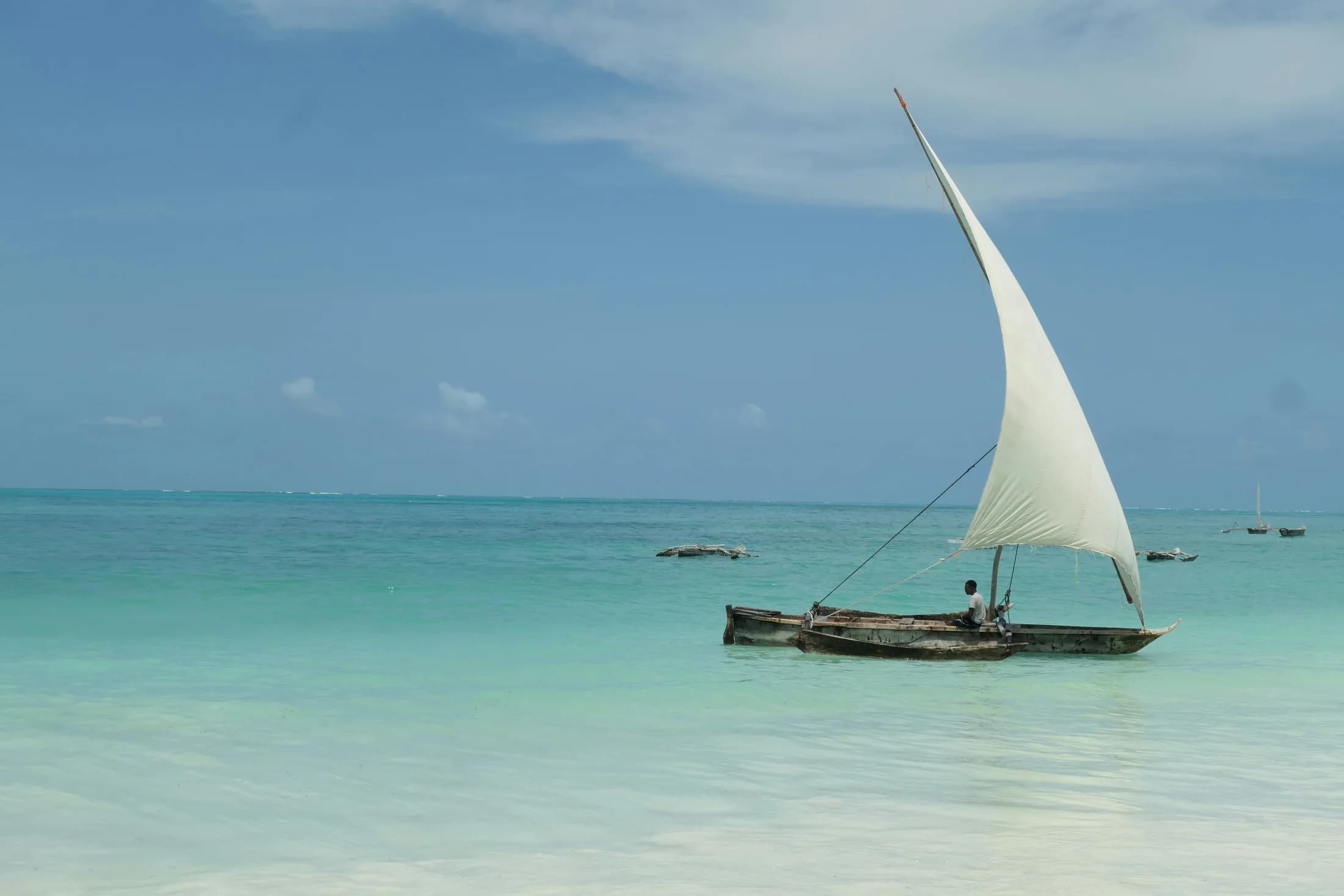 Coastal inspiration: a traditional sailing boat on turquoise water in Tanzania