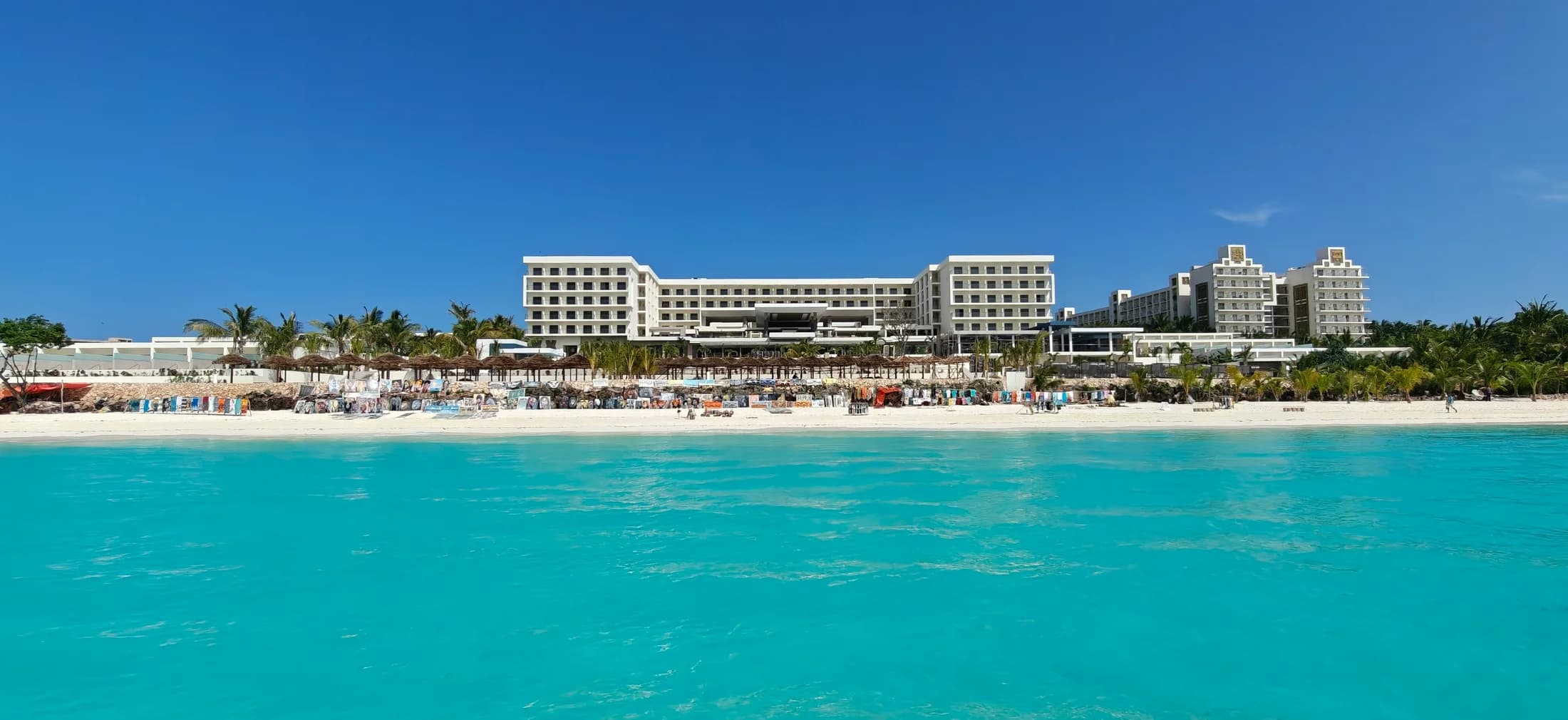 A beachfront resort and turquoise water on the Zanzibar coast